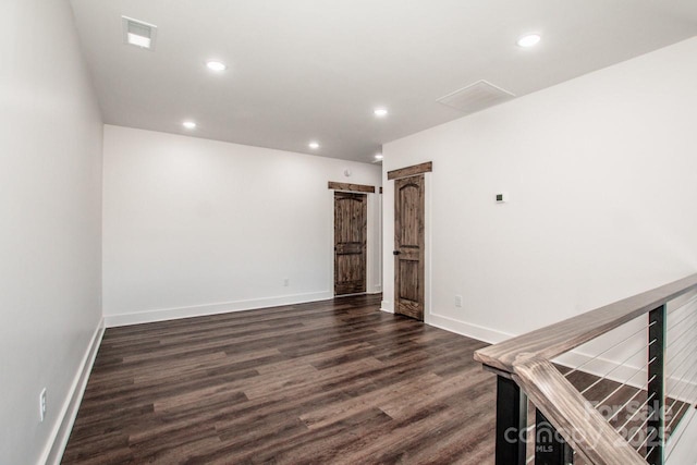 unfurnished room featuring dark hardwood / wood-style flooring