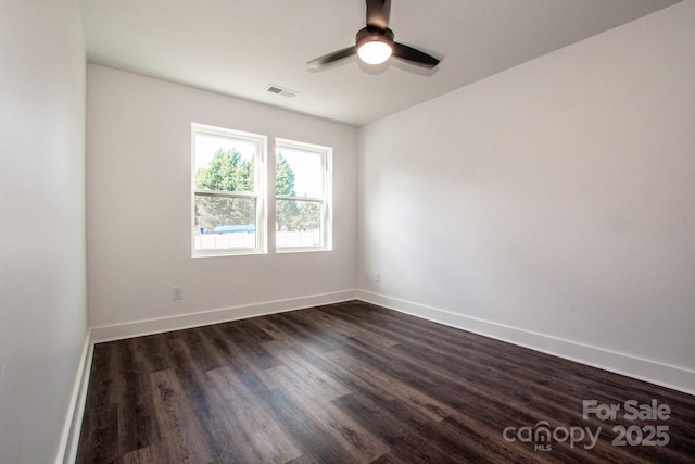 unfurnished room featuring ceiling fan and dark hardwood / wood-style flooring