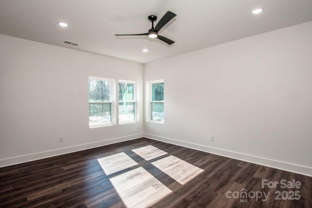 empty room featuring ceiling fan and dark hardwood / wood-style flooring