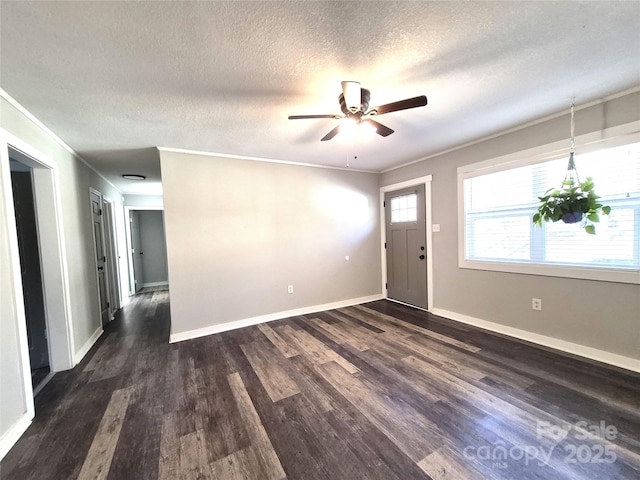 foyer featuring baseboards, ornamental molding, and dark wood finished floors