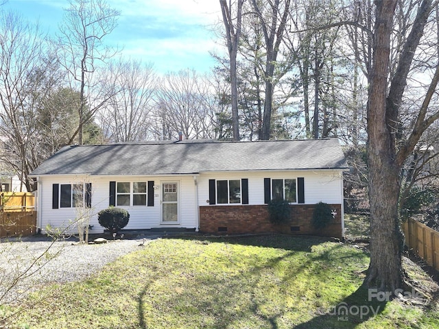 ranch-style house with a shingled roof, crawl space, fence, a front yard, and brick siding