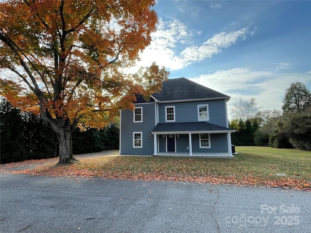 front facade with a front lawn and a porch