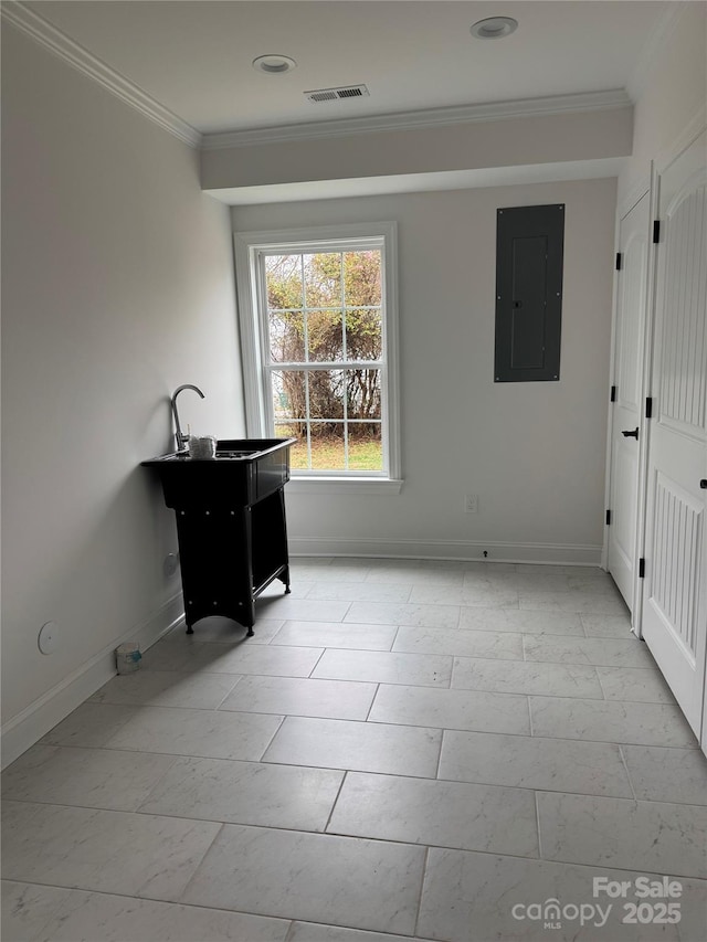 interior space featuring ornamental molding and electric panel