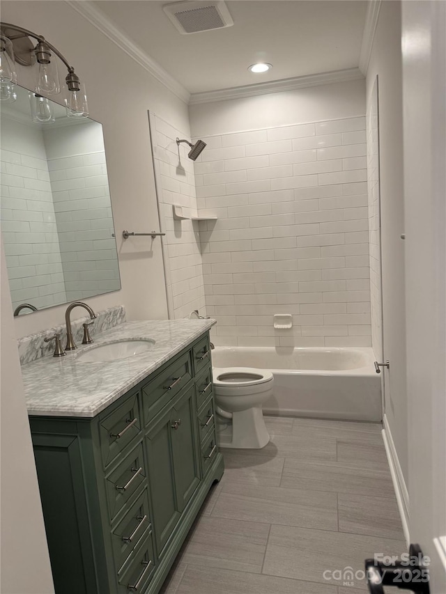 full bathroom with toilet, vanity, crown molding, and tiled shower / bath