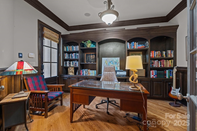 home office with ornamental molding and light wood-style flooring