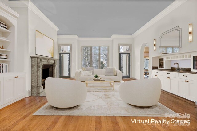 living area with a premium fireplace, wood finished floors, and a healthy amount of sunlight