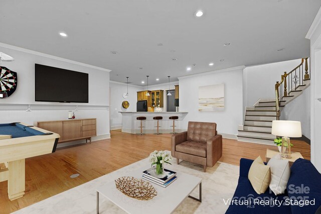 living area featuring crown molding, stairs, wood finished floors, and recessed lighting