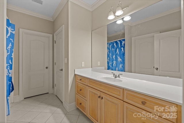 bathroom featuring baseboards, visible vents, tile patterned floors, crown molding, and vanity