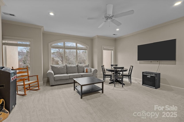 carpeted living room with recessed lighting, a ceiling fan, visible vents, baseboards, and crown molding