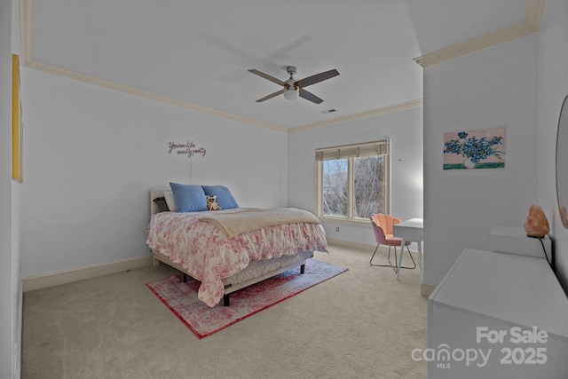 bedroom with a ceiling fan, carpet flooring, crown molding, and baseboards