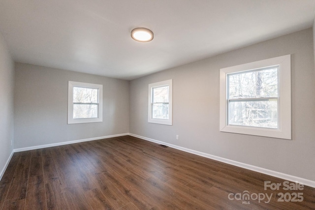 empty room with dark hardwood / wood-style floors