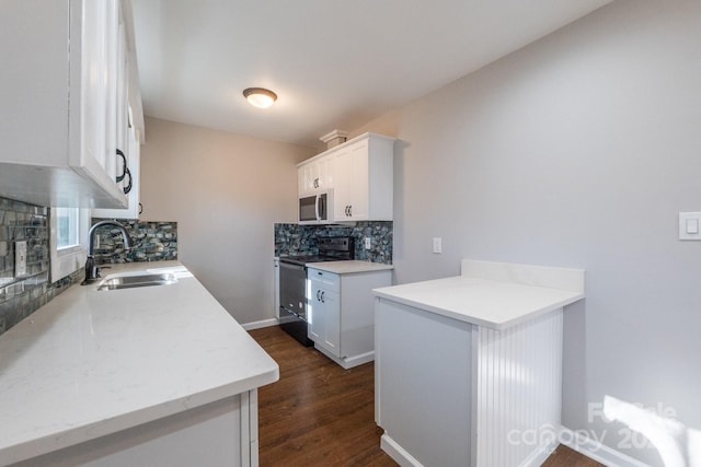 kitchen featuring backsplash, dark hardwood / wood-style flooring, electric range oven, white cabinets, and sink