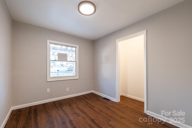 unfurnished room featuring dark hardwood / wood-style floors