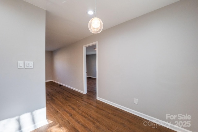 unfurnished room featuring dark hardwood / wood-style flooring