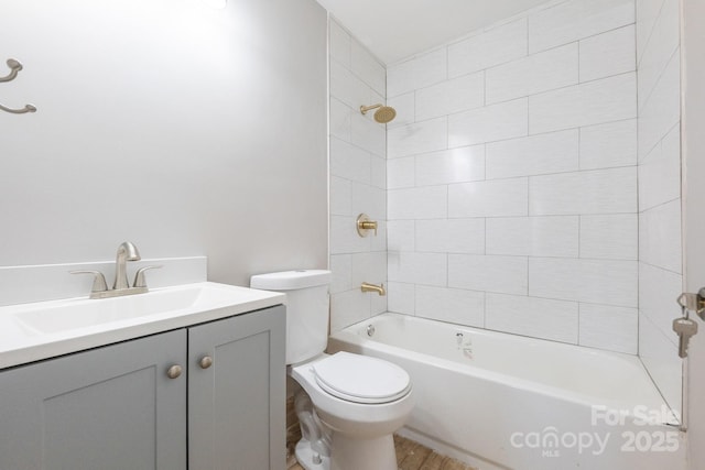 full bathroom with toilet, vanity, and tiled shower / bath combo