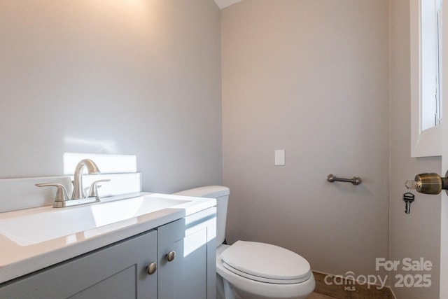 bathroom with toilet and vanity