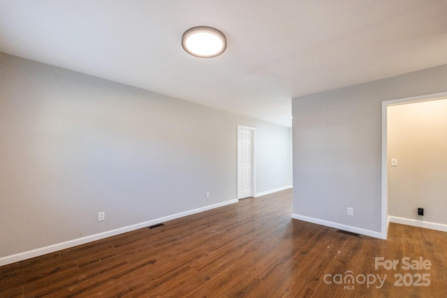 spare room featuring dark hardwood / wood-style floors