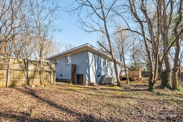 exterior space with a wooden deck and central AC