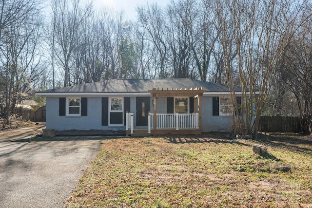 single story home with covered porch and a front lawn