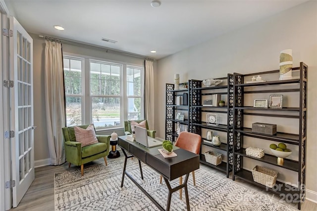 office space with light wood finished floors, baseboards, visible vents, and recessed lighting