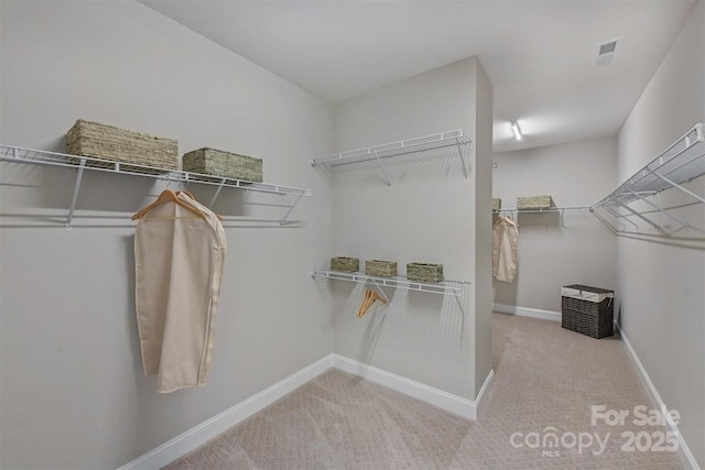 spacious closet featuring light carpet and visible vents