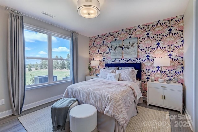 bedroom featuring light wood-type flooring, baseboards, and visible vents