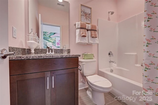 bathroom featuring shower / bath combination, visible vents, vanity, and toilet