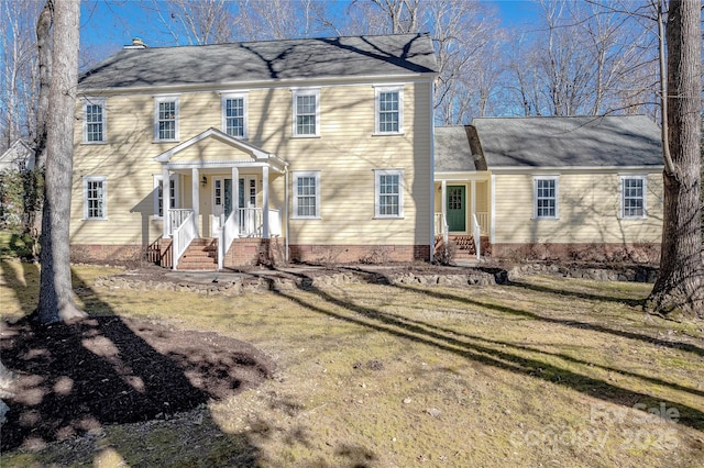 colonial inspired home with a front lawn