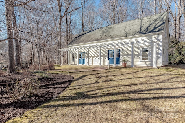 exterior space featuring a front lawn and a pergola