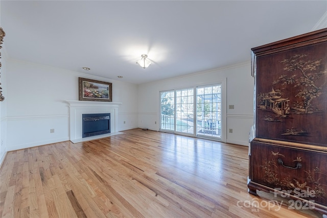 living room with crown molding and light wood-type flooring