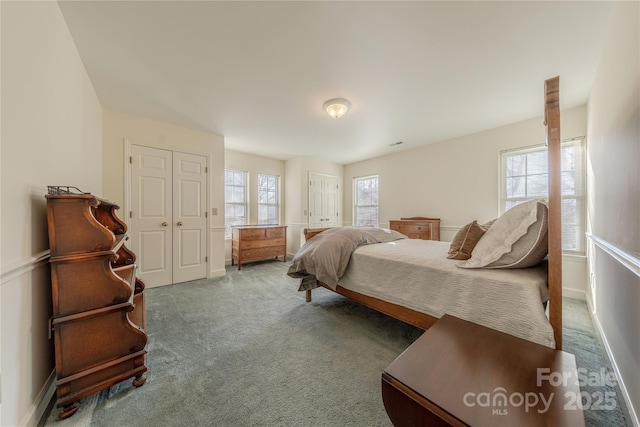 bedroom with carpet floors and multiple windows