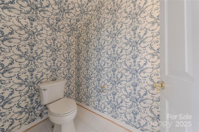 bathroom featuring toilet and tile patterned flooring