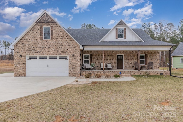 view of front of house with covered porch, a front lawn, and a garage