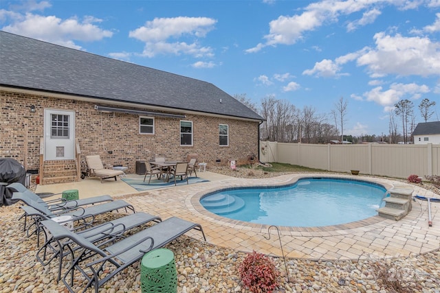 view of pool with entry steps, a fenced backyard, a grill, a fenced in pool, and a patio area