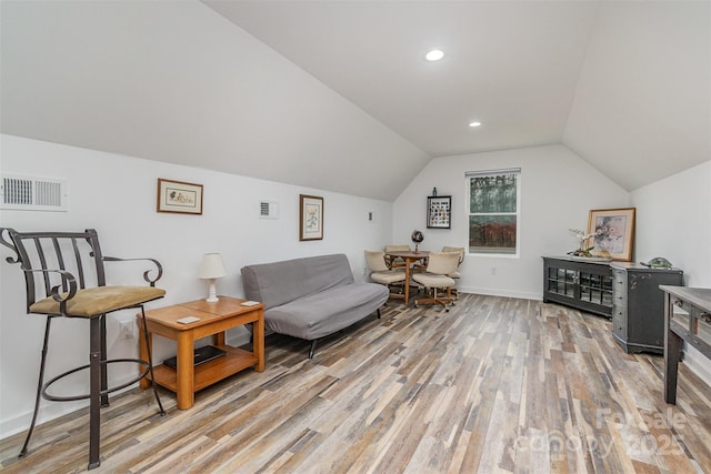 sitting room with lofted ceiling, recessed lighting, visible vents, and light wood finished floors