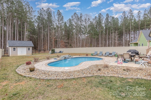 view of pool featuring a fenced in pool, a lawn, an outdoor structure, a fenced backyard, and a patio area