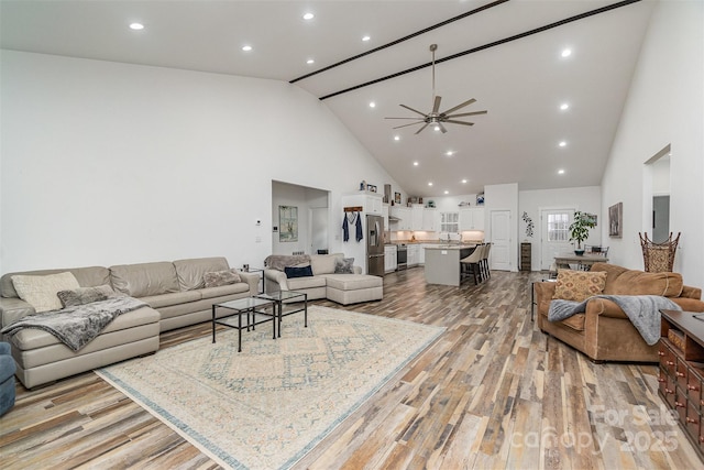 1076 Furnace Rd, Iron Station, NC 28080 - living area featuring high vaulted ceiling, a ceiling fan, light wood-style floors, and recessed lighting