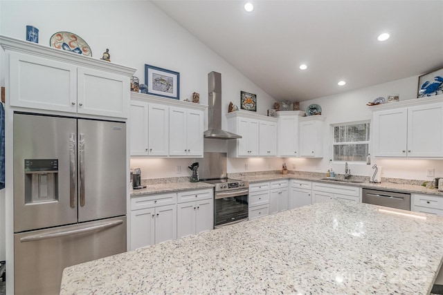 1076 Furnace Rd, Iron Station, NC 28080 - kitchen featuring appliances with stainless steel finishes, wall chimney range hood, a sink, vaulted ceiling, and recessed lighting