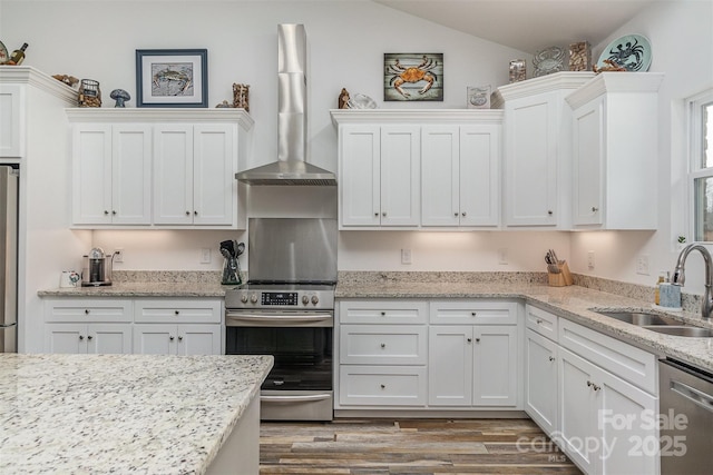 1076 Furnace Rd, Iron Station, NC 28080 - kitchen with a sink, wall chimney exhaust hood, stainless steel appliances, white cabinetry, and vaulted ceiling
