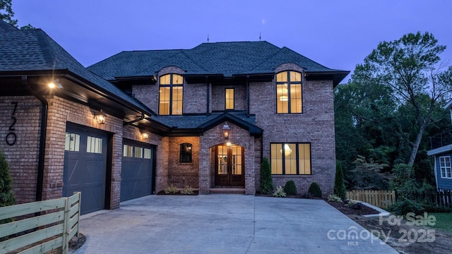 french country home with a garage