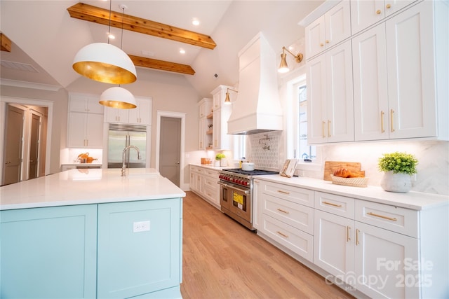 kitchen featuring decorative light fixtures, decorative backsplash, white cabinetry, premium appliances, and custom range hood