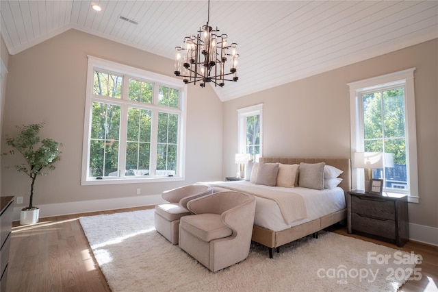 bedroom with light hardwood / wood-style floors, wooden ceiling, an inviting chandelier, and vaulted ceiling