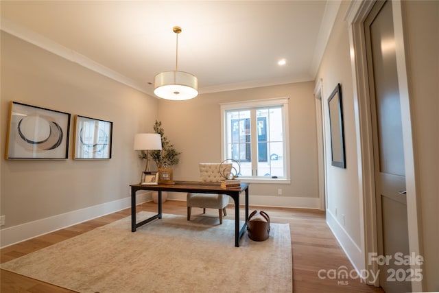 office space with crown molding and light hardwood / wood-style flooring