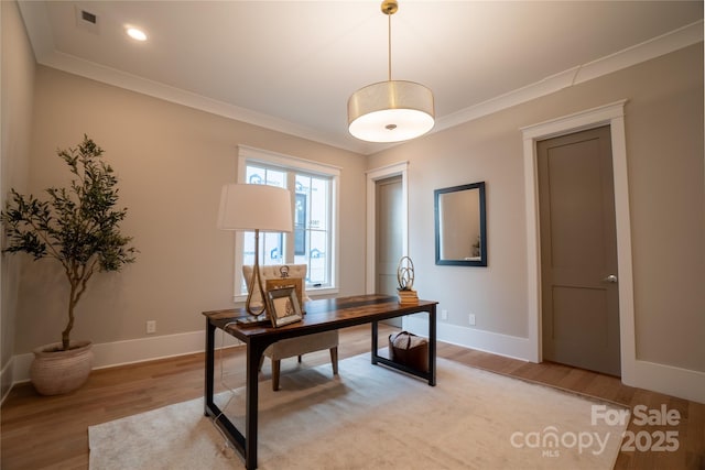 office space featuring crown molding and light hardwood / wood-style floors