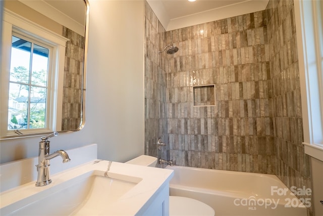 full bathroom featuring toilet, tiled shower / bath combo, and vanity