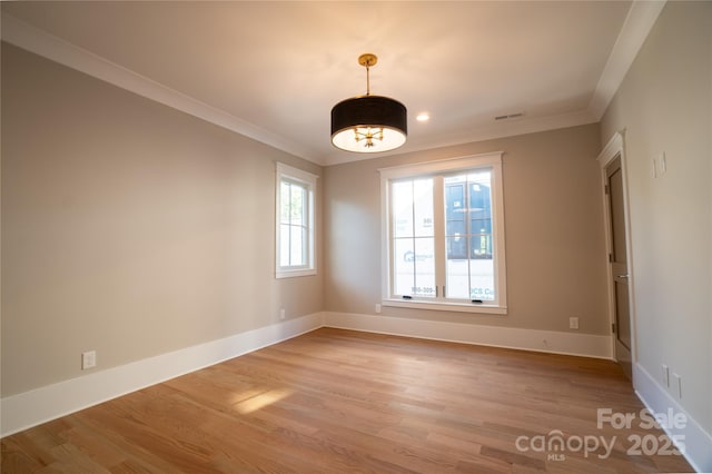 unfurnished room with ornamental molding and light hardwood / wood-style flooring