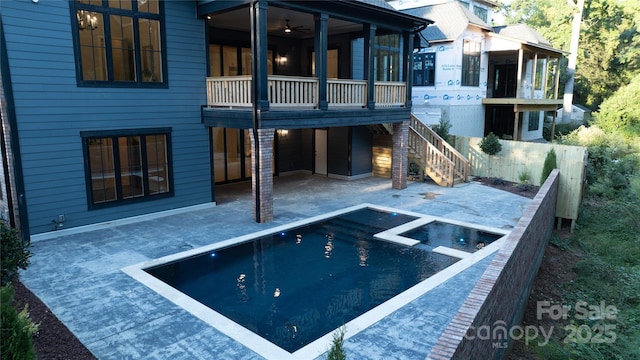 view of pool with ceiling fan, a sunroom, and a patio