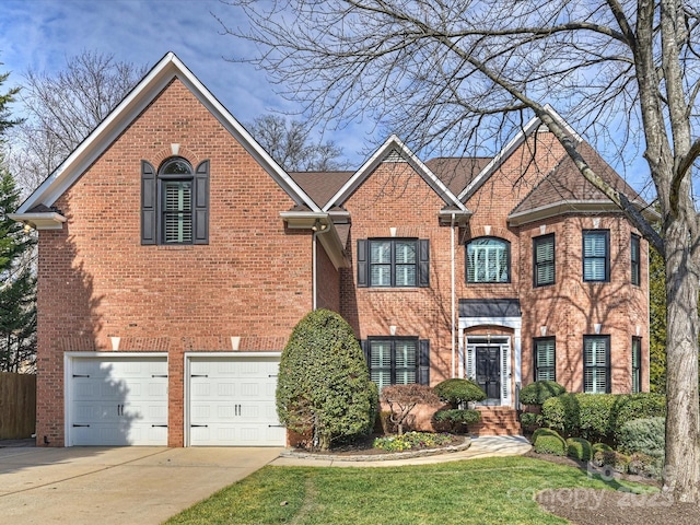 view of front of house with a garage, concrete driveway, and brick siding