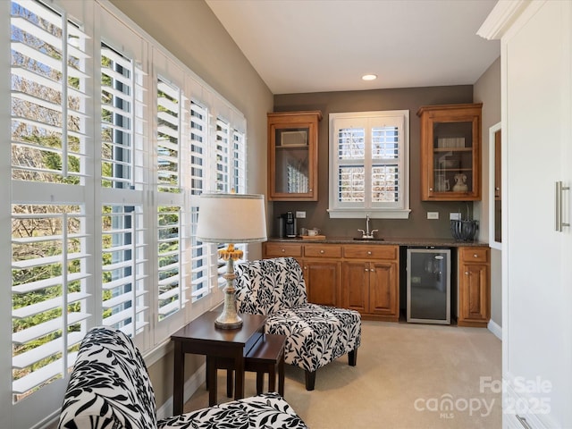 bar with a sink, indoor wet bar, beverage cooler, and plenty of natural light