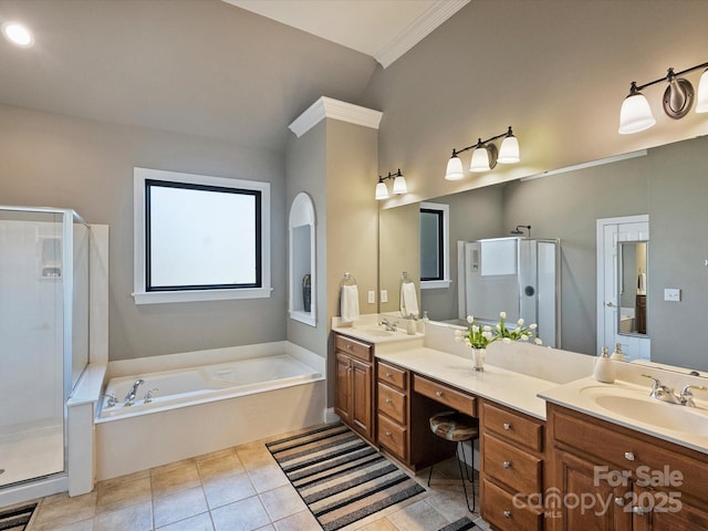 bathroom with a sink, visible vents, double vanity, and a garden tub